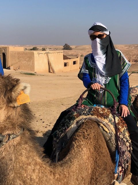 KC riding a camel