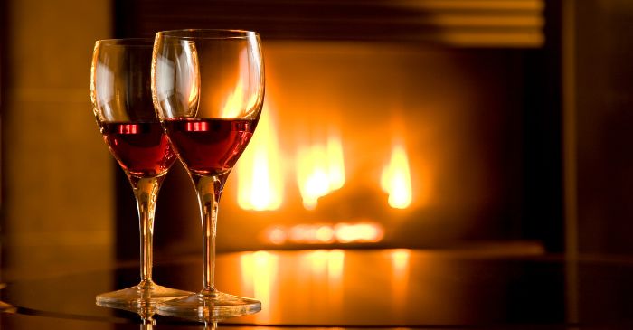 Wine glasses and fireplace pic for our Online Dating terms post