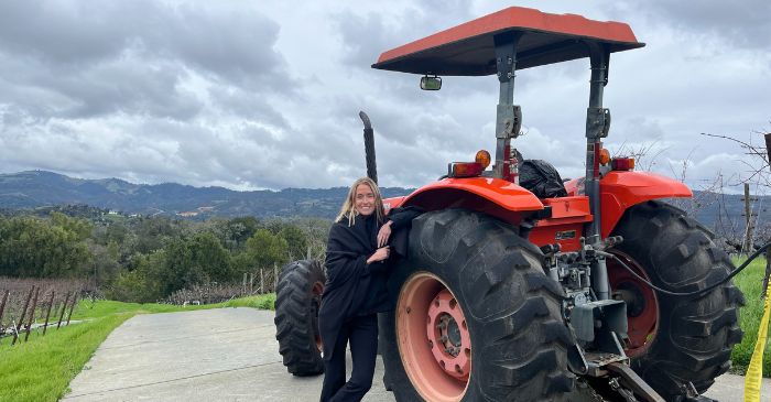 Karen pictured with a farm tractor in Sonoma for our post on love where you live